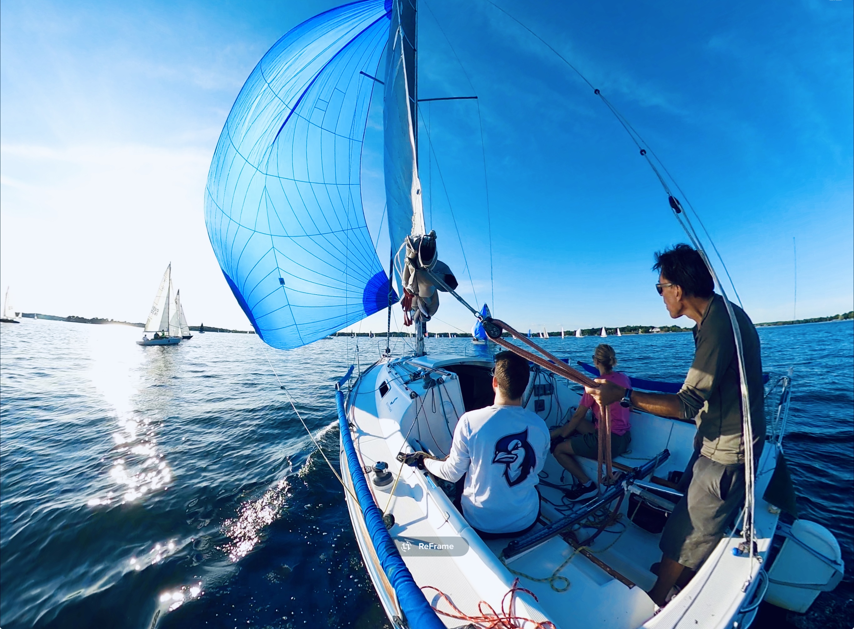 BlueJ sailing with beautiful blue and white spinnaker on Lake Minnetonka