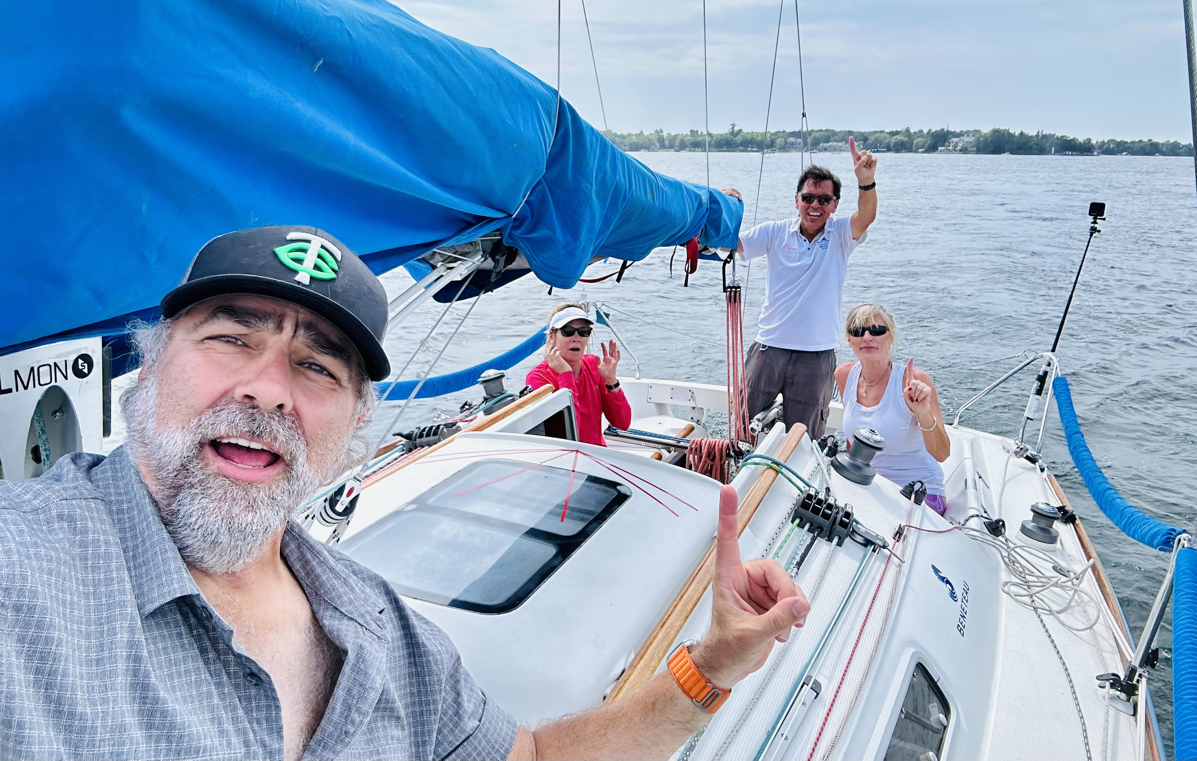 Happy crew and guests sailing on Lake Minnetonka, smiling and enjoying charter