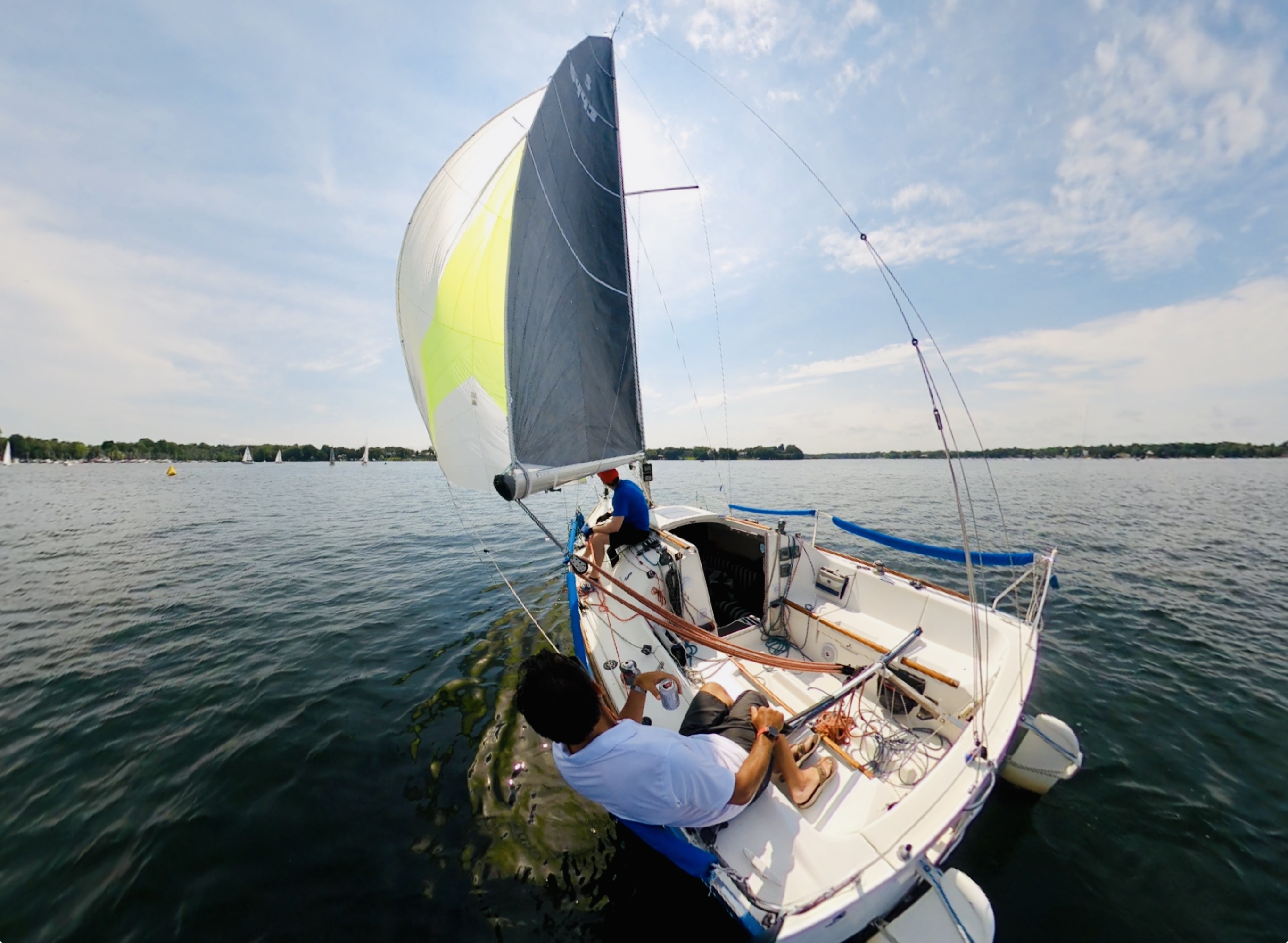 Sailing charter adventure on Lake Minnetonka, guests enjoying 4-hour day sail with spinnaker